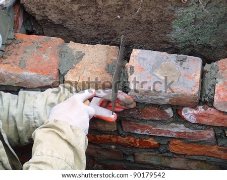 Construction of the wall of red brick
