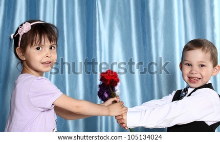 the boy and the girl hold flowers