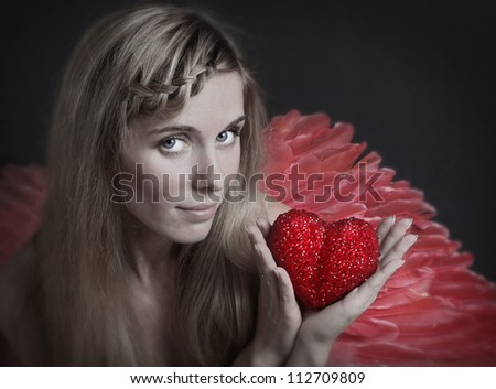 the beautiful girl with red heart in hands