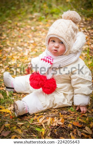 emotions of the beautiful little girl in the autumn wood