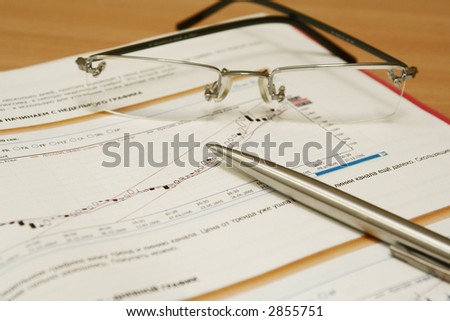 The handle lays on the schedule beside glasses