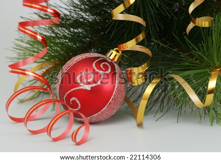 The New Year\'s sphere and fur-tree branch are on a white background