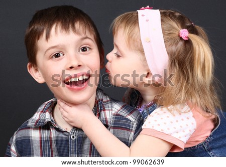 The sister kisses the  brother