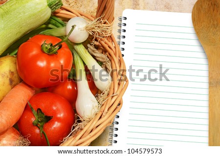 Fresh vegetables on the old tablecloth and paper for notes and recipes