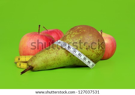 Close up of apples and pear with measuring tape