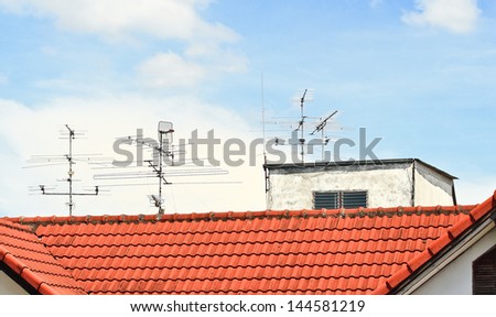 TV antenna on red roof.