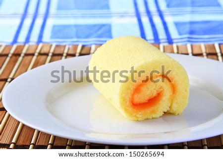 Slice Roll Cake on white plate./Orange Cake.