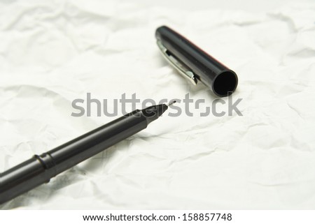 Black Pen on white note.