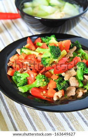 stir fried vegetables with pork in red dish./Fried vegetables.