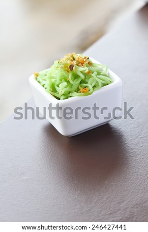 green noodle with Fried garlic in white cup.