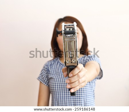 Hand holding shop pricing gun