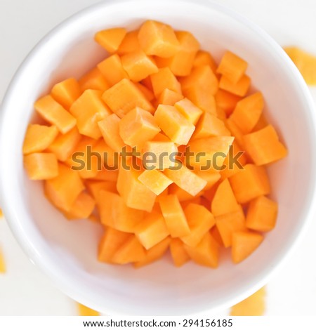 Carrot slices in white bowl.