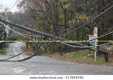 GREENWiCH, CT - NOVEMBER 02:  Broken electrical pole on Lake Avenue near Exit 28 on the Merritt Parkway after hurricane Sandy 2012 on November 02, 2012 in Greenwich, CT.