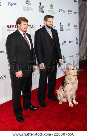 NEW YORK, NY - NOVEMBER 05: (L-R) Jake Young, Marshall Peters  and Service Dog Lundy attend 2014 Stand Up For Heroes at Madison Square Garden on November 5, 2014 in New York City