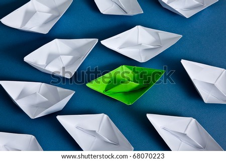 White paper boats and one green boat.