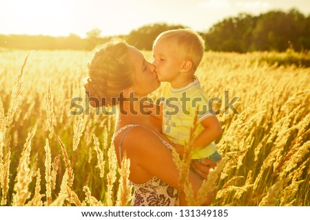 Mother and Son Having Fun. Son kissing his mother. Outdoor shot