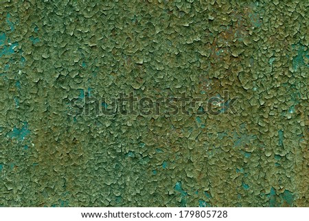 Real green grunge textured background with cracked paint on metal.