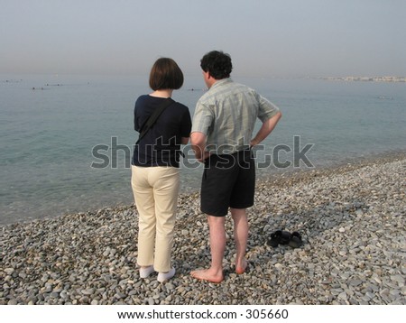 Couple at the beach of Nice, France an early, misty morning.