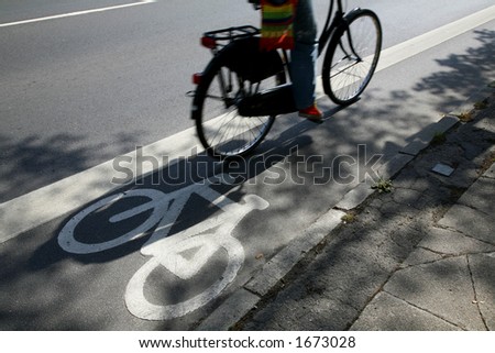 Cyclist passing by on urban cycle path.