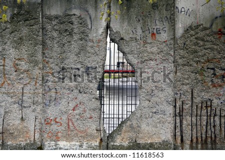 Graffiti and greetings on one of the remaining sections of the old cold war Berlin wall - Germany. This section with a big hole to freedom.