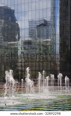 Fountain in front of futuristic corporate office buildings - La Defense, Paris.