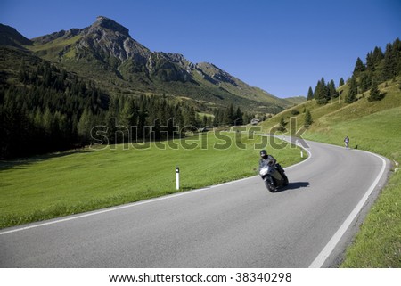Speedy motorbike on mountain road - Dolomites, Italy.