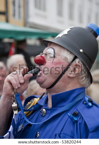 SVENDBORG, DK - MAY 22:  Clown  P C Bluey blowing  his whistle  in the street during 12th International Clown Festival   May 22, 2010 Svendborg, Denmark.