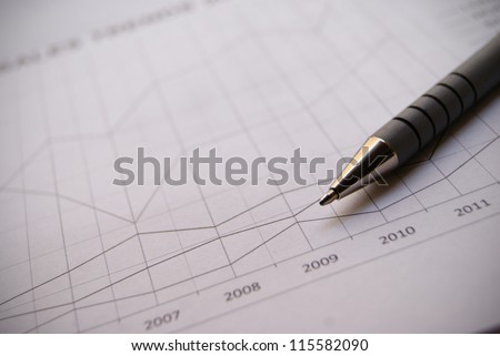 Pen on Financial Chart with positive growth pattern