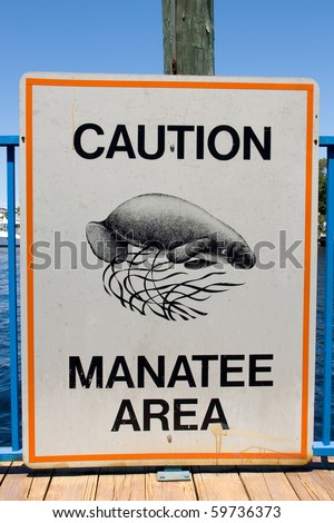 A sign warning boats to slow down for manatees