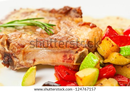 Grilled pork loin with vegetables on the plate