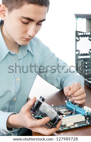Technician repairing computer hardware in the lab. Small DOF