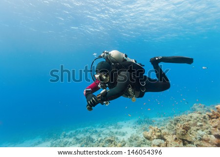 Male scuba diver swimming under water
