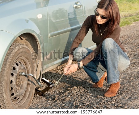 woman and the car with punctured wheel