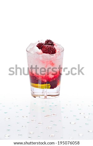 Cold alcoholic cocktail. Glass with drink stands on the surface covered with water drops