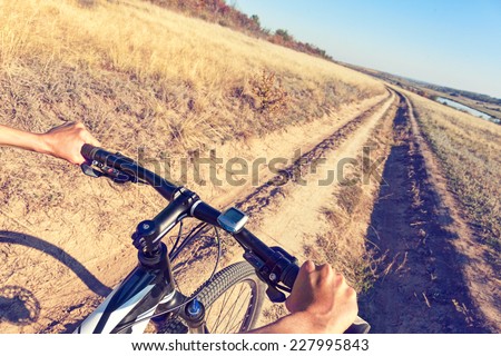 Close up bicycle rider\'s hands  on a mountain bicycle handlebar.