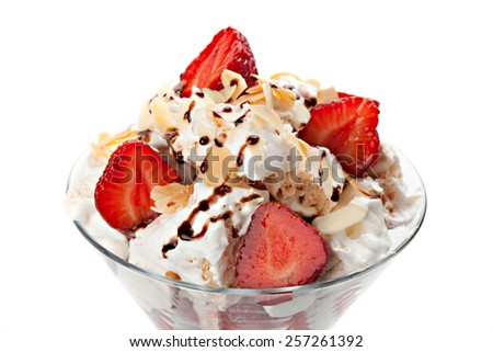close up of ice- cream with strawberries and whipped cream,isolated on white background.