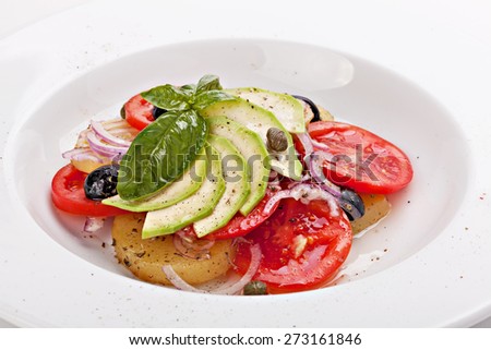 Closeup of vegetable salad on plate isolated on white