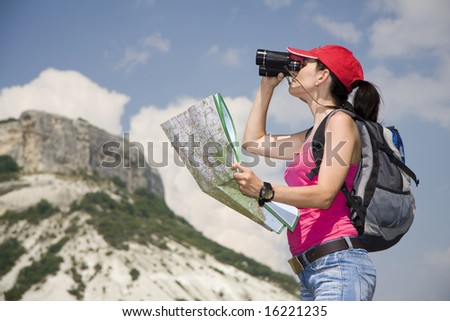 woman with the binoculars in the mountains