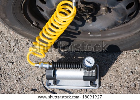 inflating tire by the electric pump on the roadside