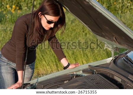 woman looking in the broken engine