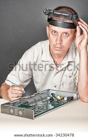 Engineer repairing circuit board, in computer equipment. coarse style picture