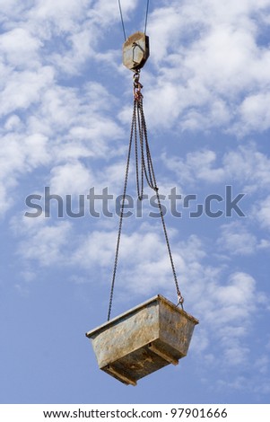 Crane basket over a cloudy sky