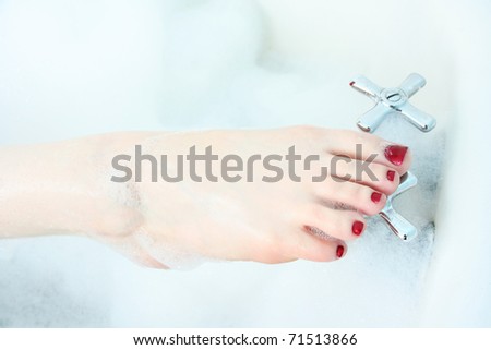 Close up of woman\'s foot in bubble bath