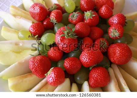 Strawberry, apple, grapes. Fresh fruit on the table