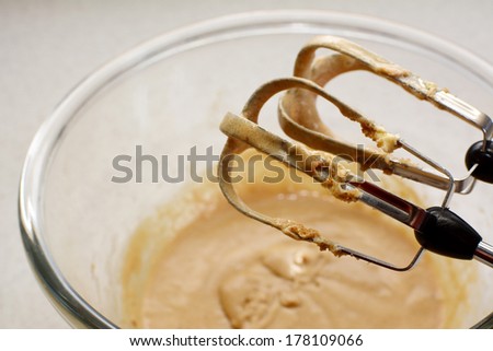 Hand mixer beaters mixing a smooth cookie dough batter