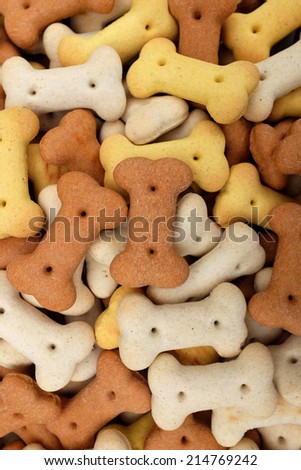 Mixed dog biscuits as a vertical abstract background texture