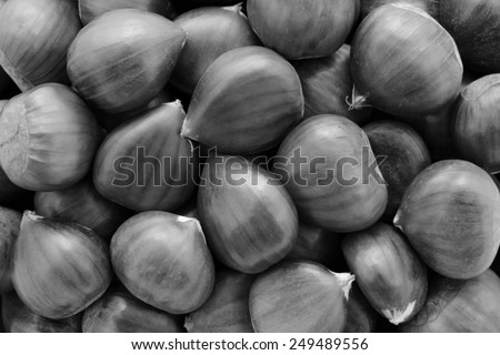 Sweet chestnuts as an abstract background texture - monochrome processing