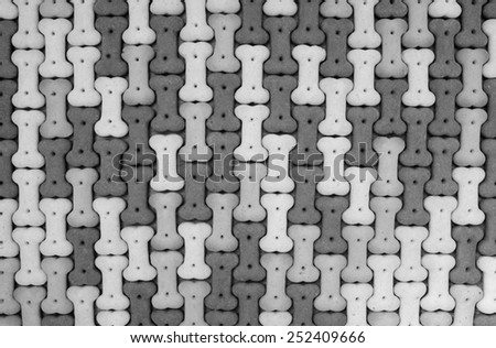 Mixed dog biscuits as an abstract tessellated background texture - monochrome processing