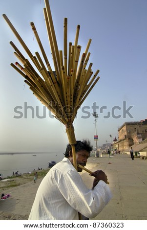 VARANASI, INDIA - APRIL 2: A Flute player on the ghats of Ganga plays tunes of Lord Rama on the auspicious occasion of Ramnavani festival on April 2, 2011 at Varanasi, Uttar Pradesh, India.