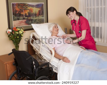 Nurse interacting with mature female patient in private health care setting.